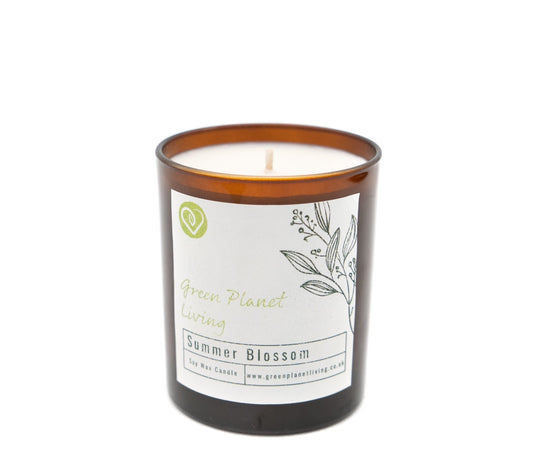 close up summer blossom candle label on an amber jar on a white background