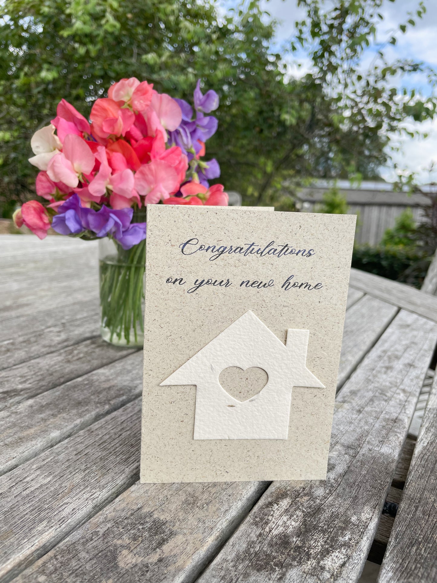 Moving house card with detachable seed paper house.