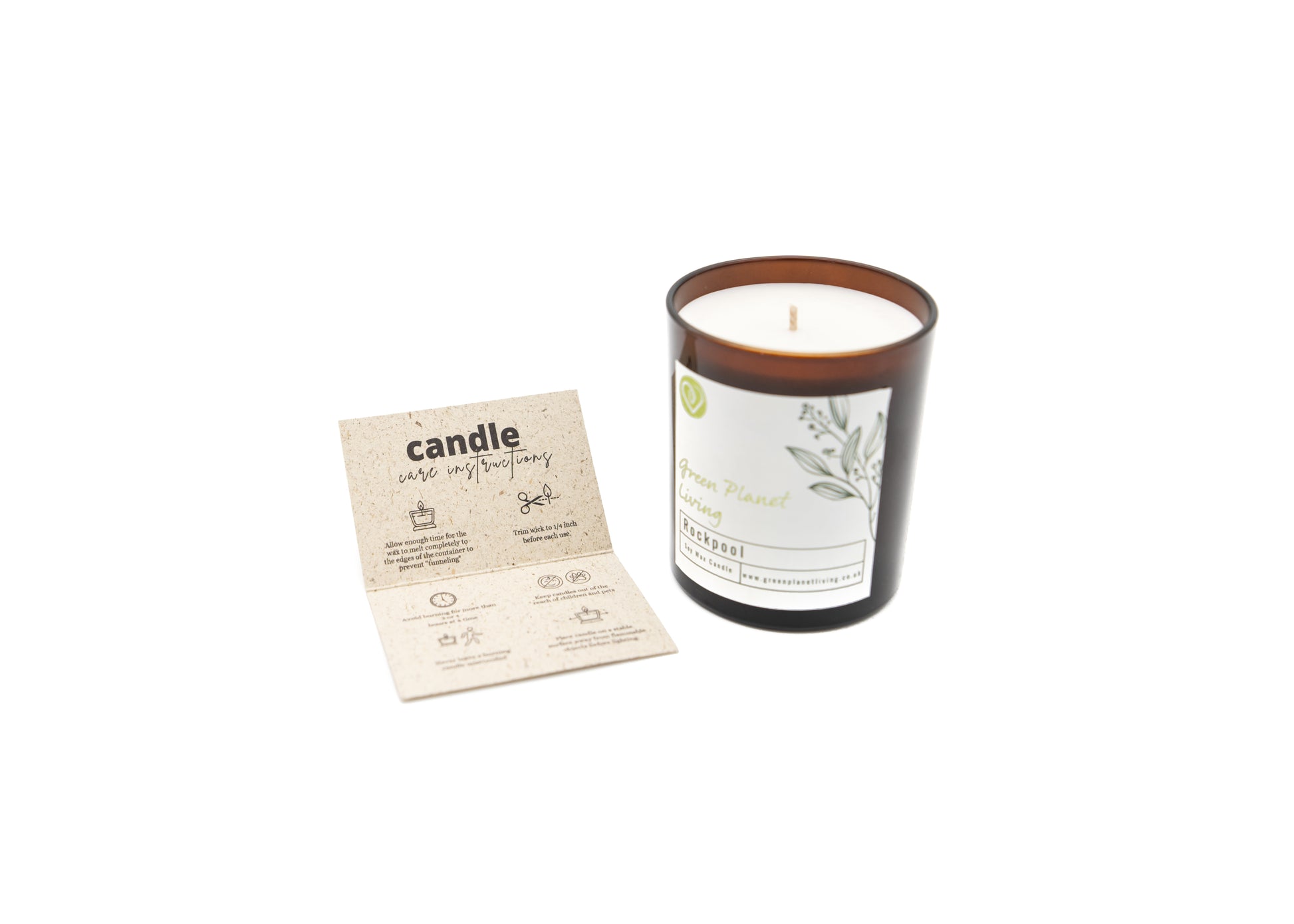 green planet living Rockpool candle in amber jar sat with candle care card on a white background